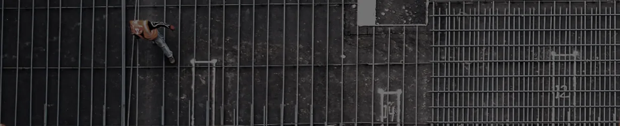 image of construction worker walking of rebar